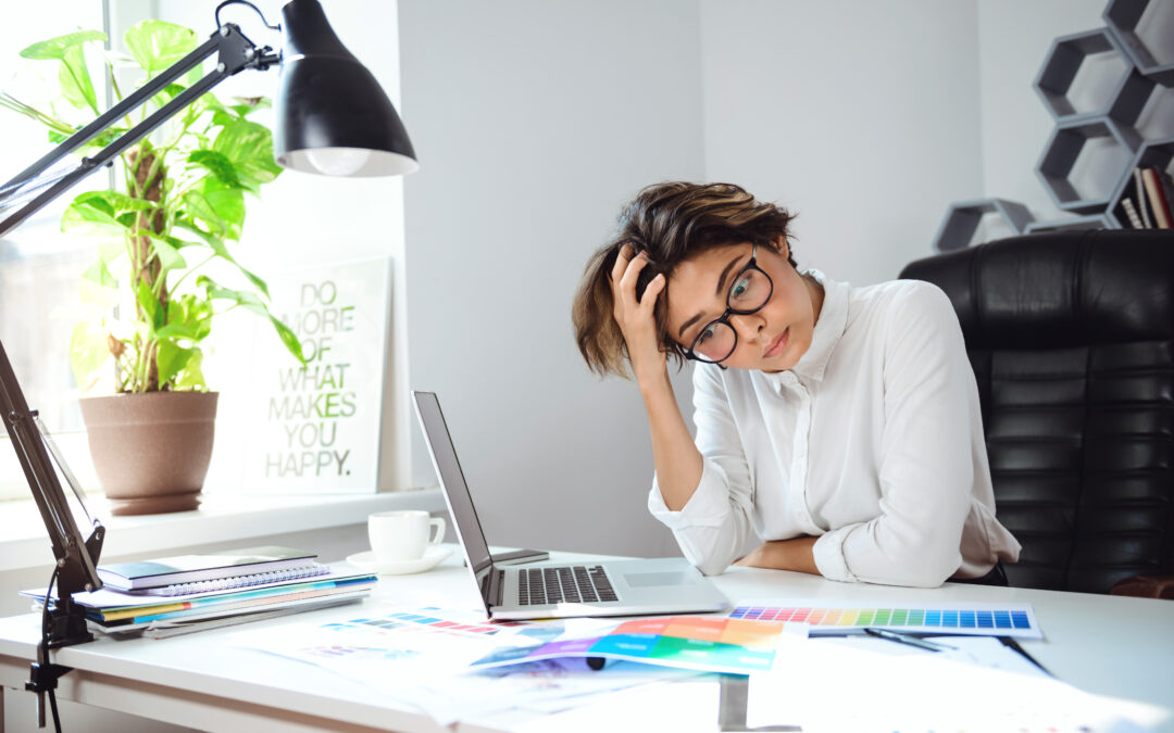 Young Beautiful Businesswoman Thinking At Workplace In Office.
